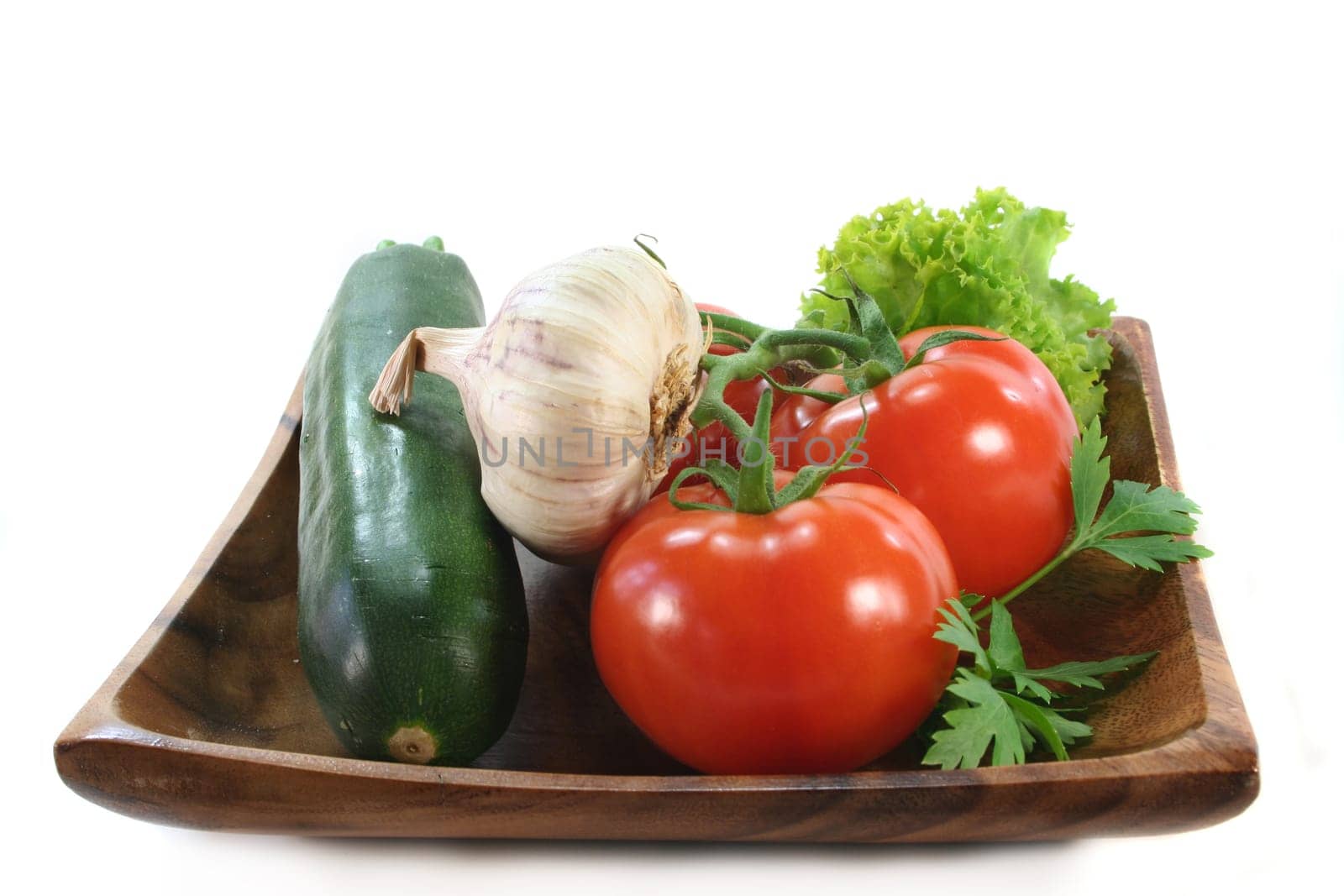 a wooden plate with various vegetables