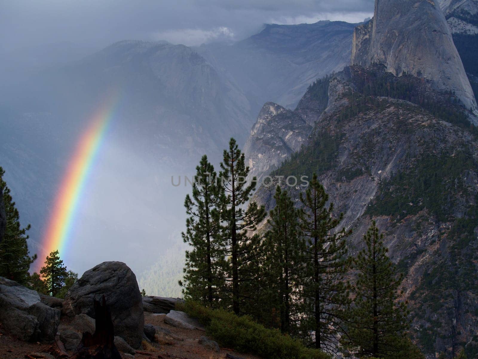 A rainbow in the fog beside half dome in Yosemite National Park, California.
