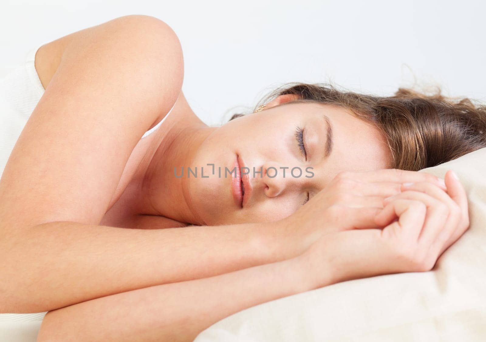 Pretty young woman sleeps in her bed