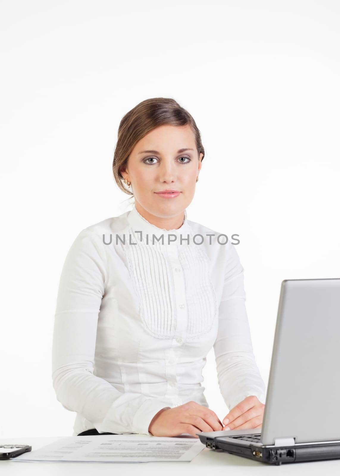 Smiling young businesswoman sitting at her workplace