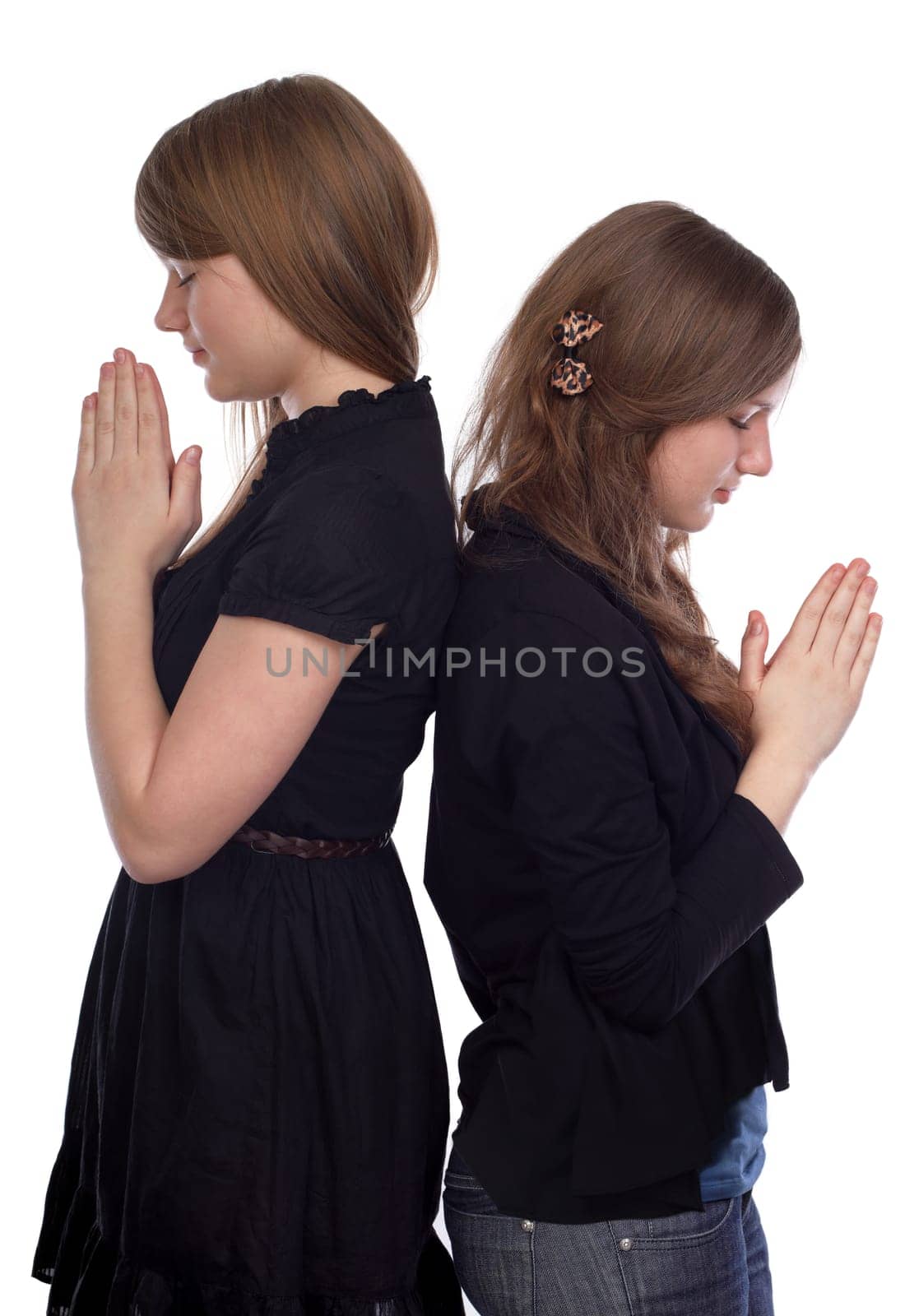 Two girls standing back to back at the time of prayer
