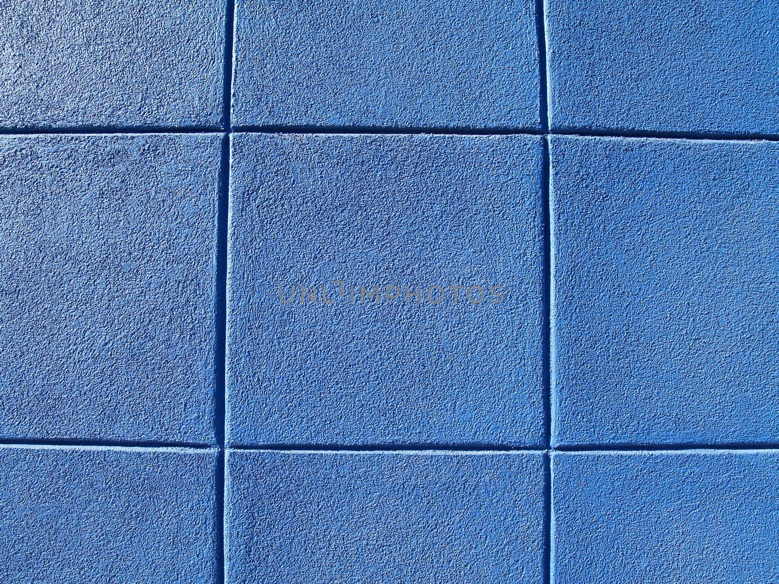 Blue exterior concrete block wall in a tic-tac-toe pattern.