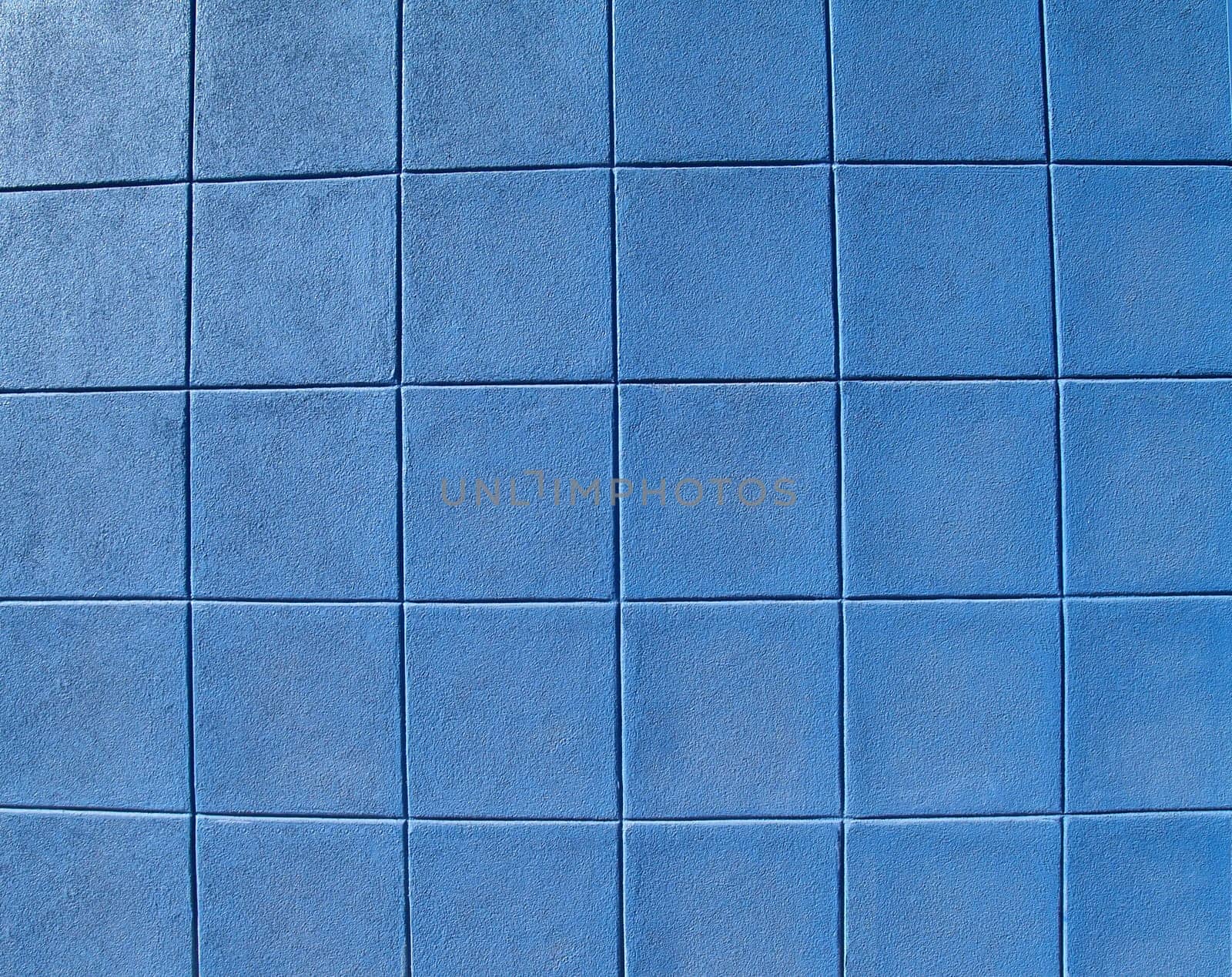 Blue concrete block exterior wall styled in rows of squares.