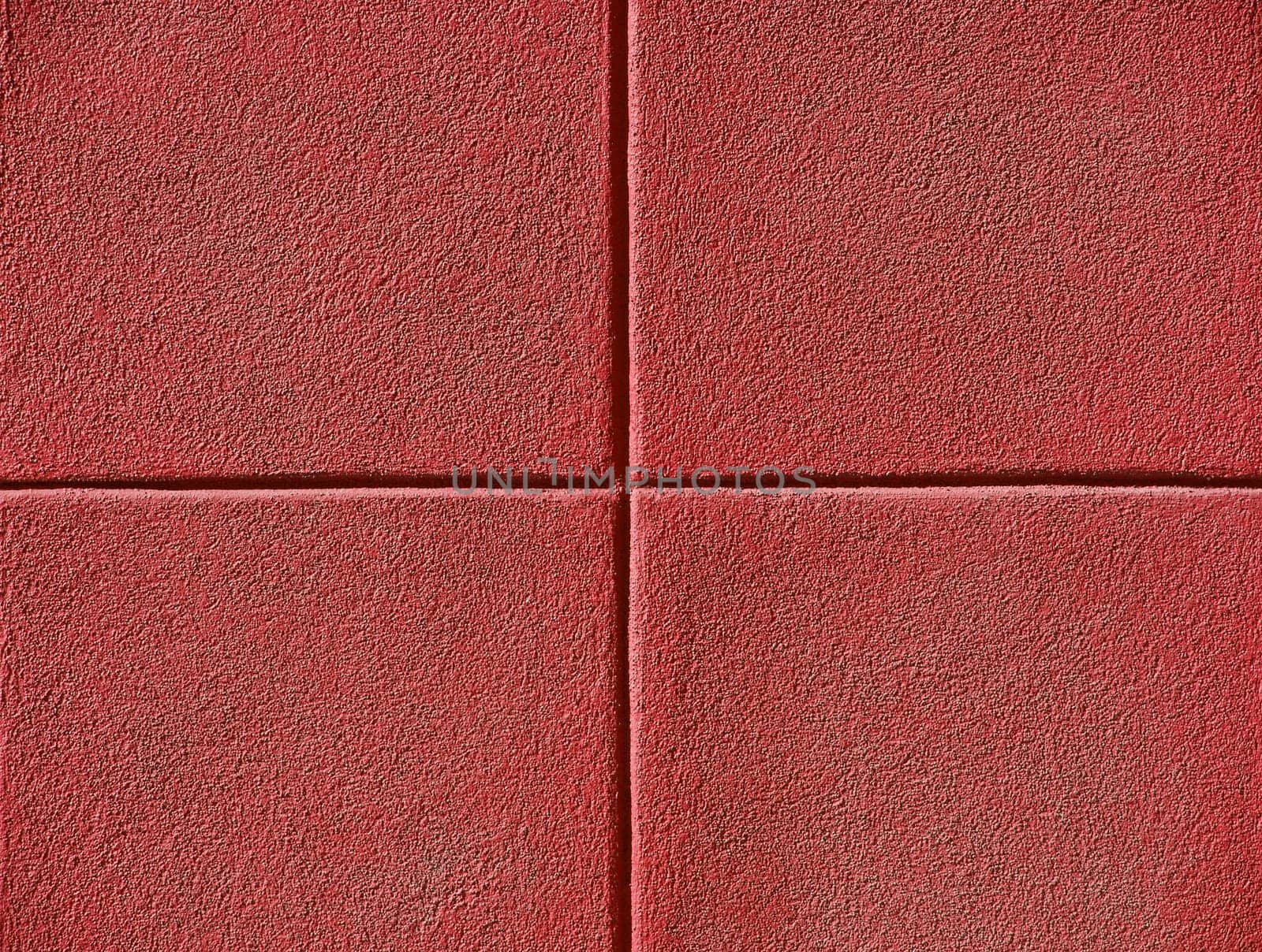 Four red squares on a concrete wall, background and copy space.