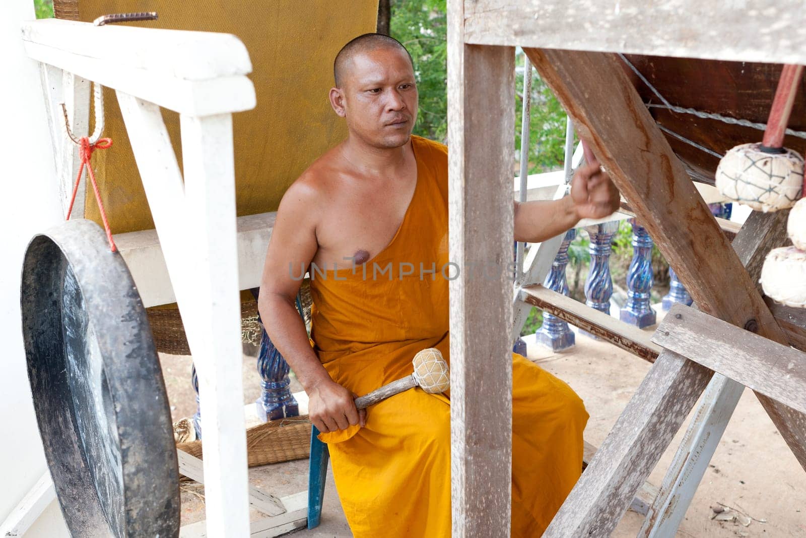 Buddhist monk doing spiritual drumming in the temple