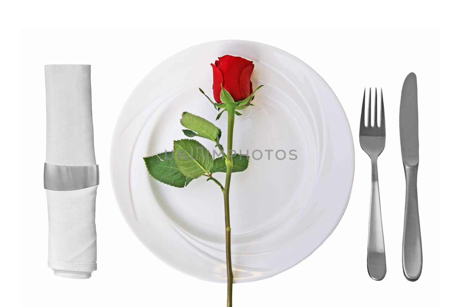 Place setting on whtie plate and red rose on white Background