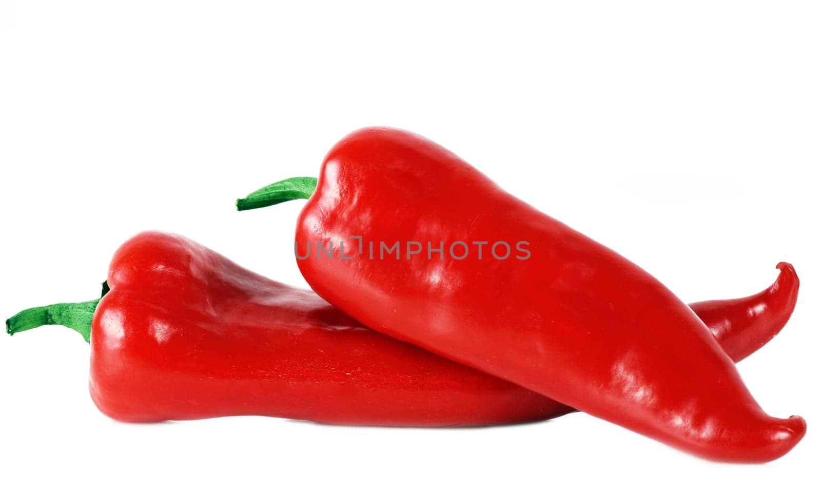 Two red peppers isolated on white