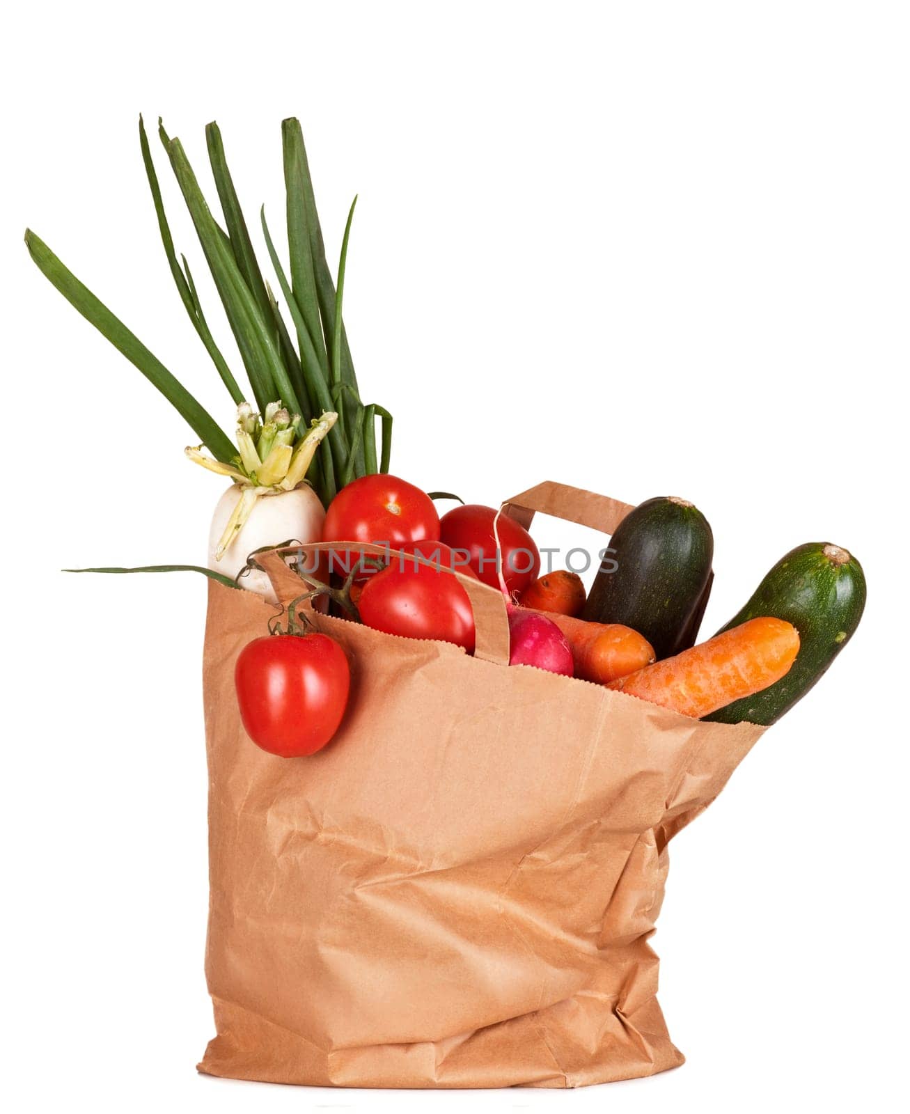 Grocery bag with vegetables isolated on white