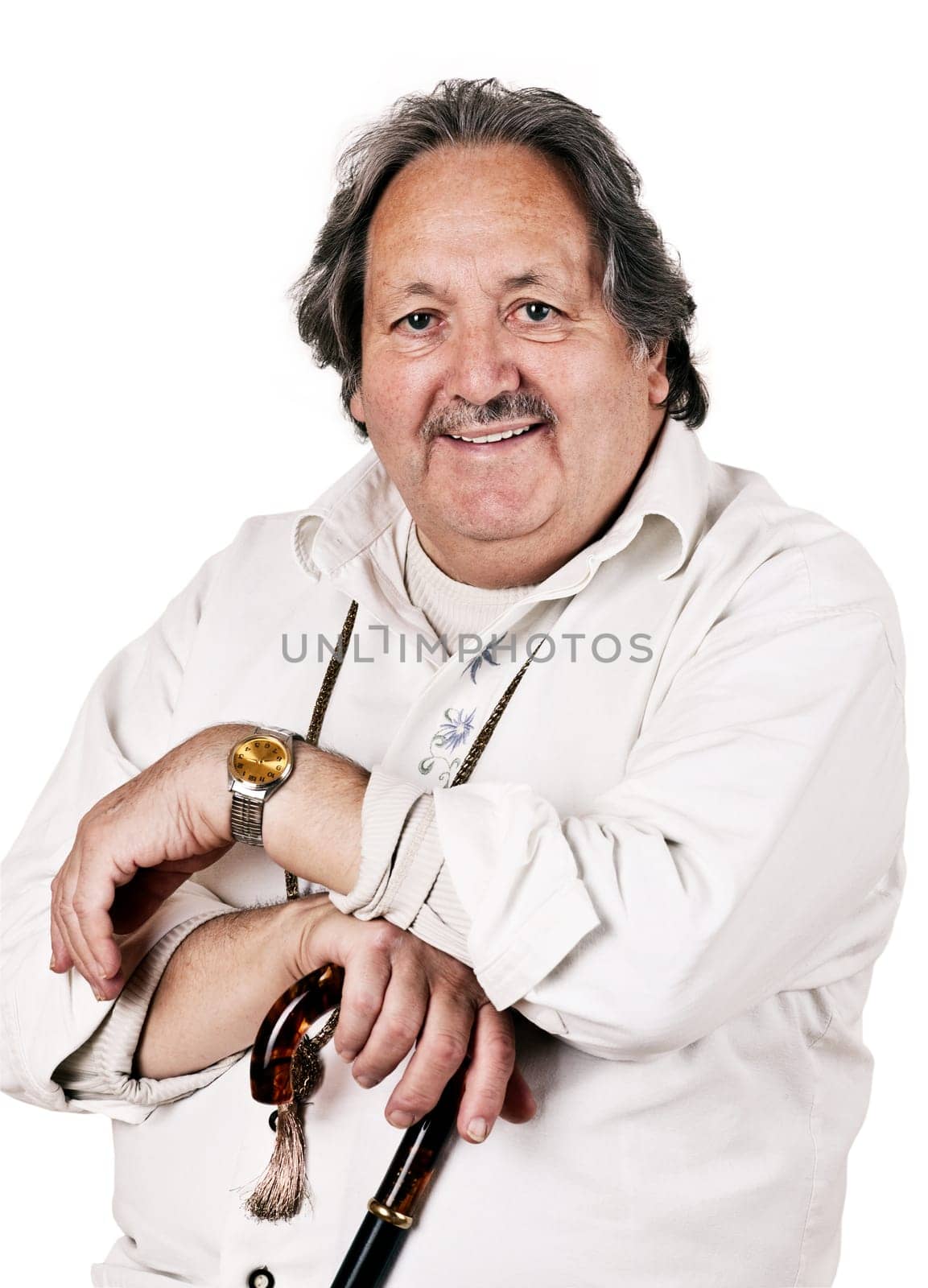 65 years old man in a white shirt, looking into the camera with a smile on his face.