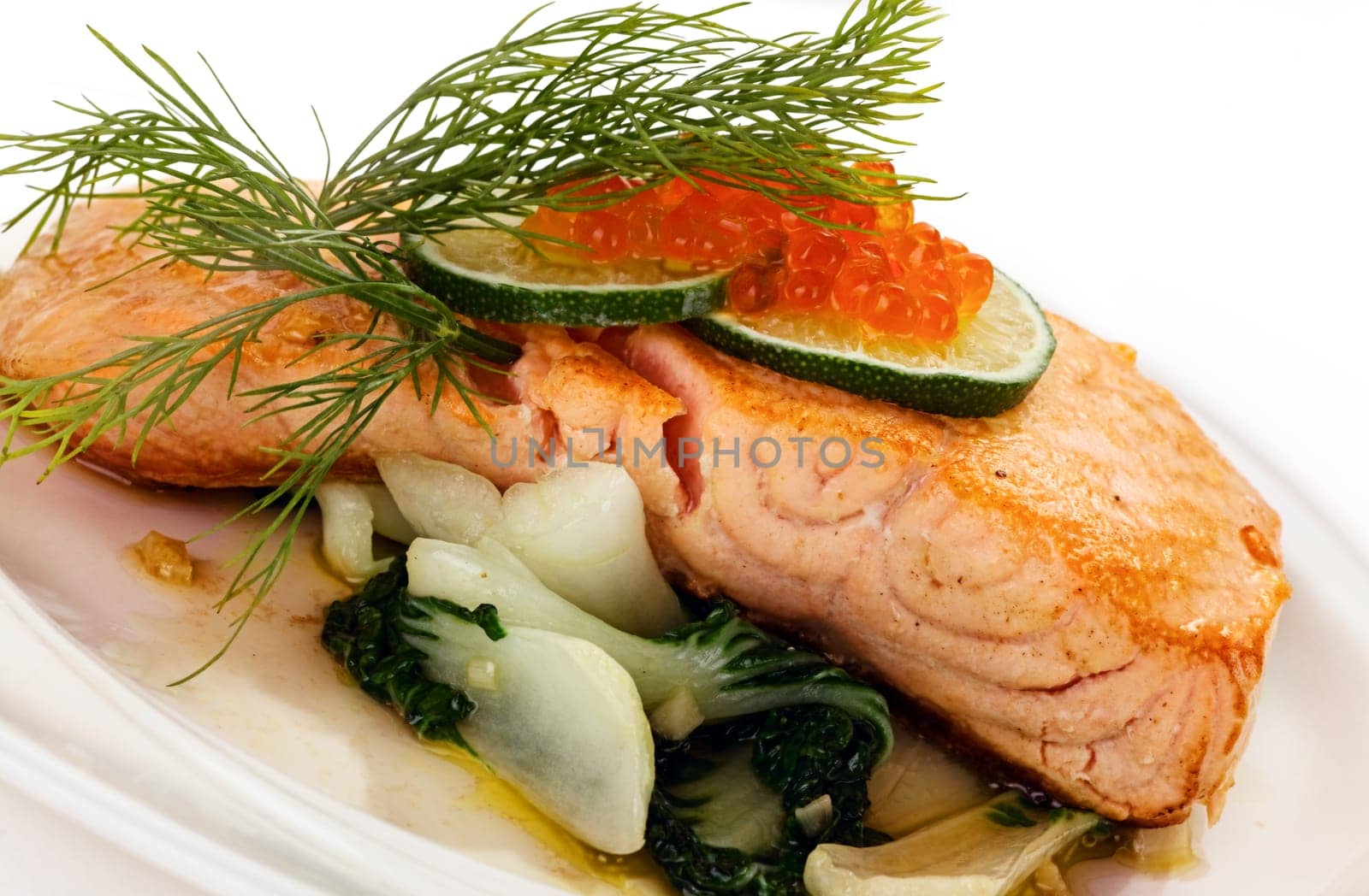 Broiled salmon steak with spinach and red caviar