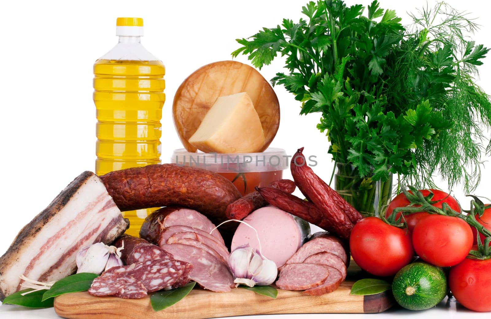 Arrangement variety of processed cold meat products with vegetable on white background