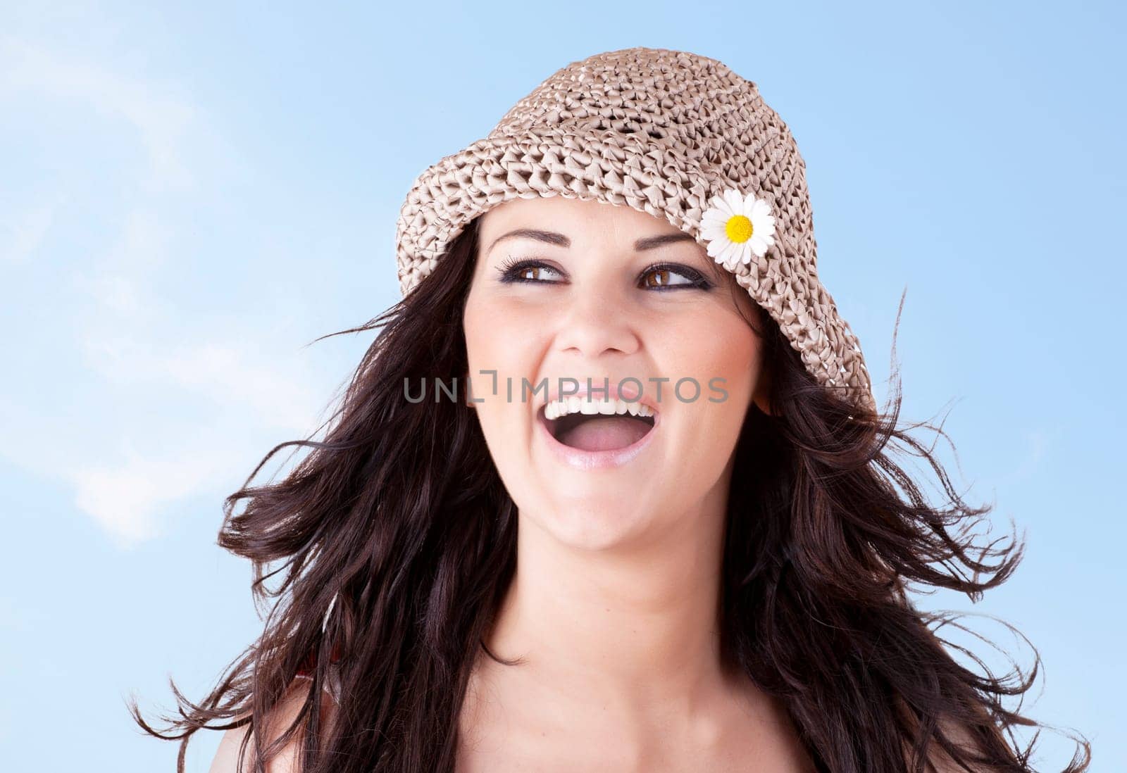 Girl with a smile and friendly expression on blue sky background