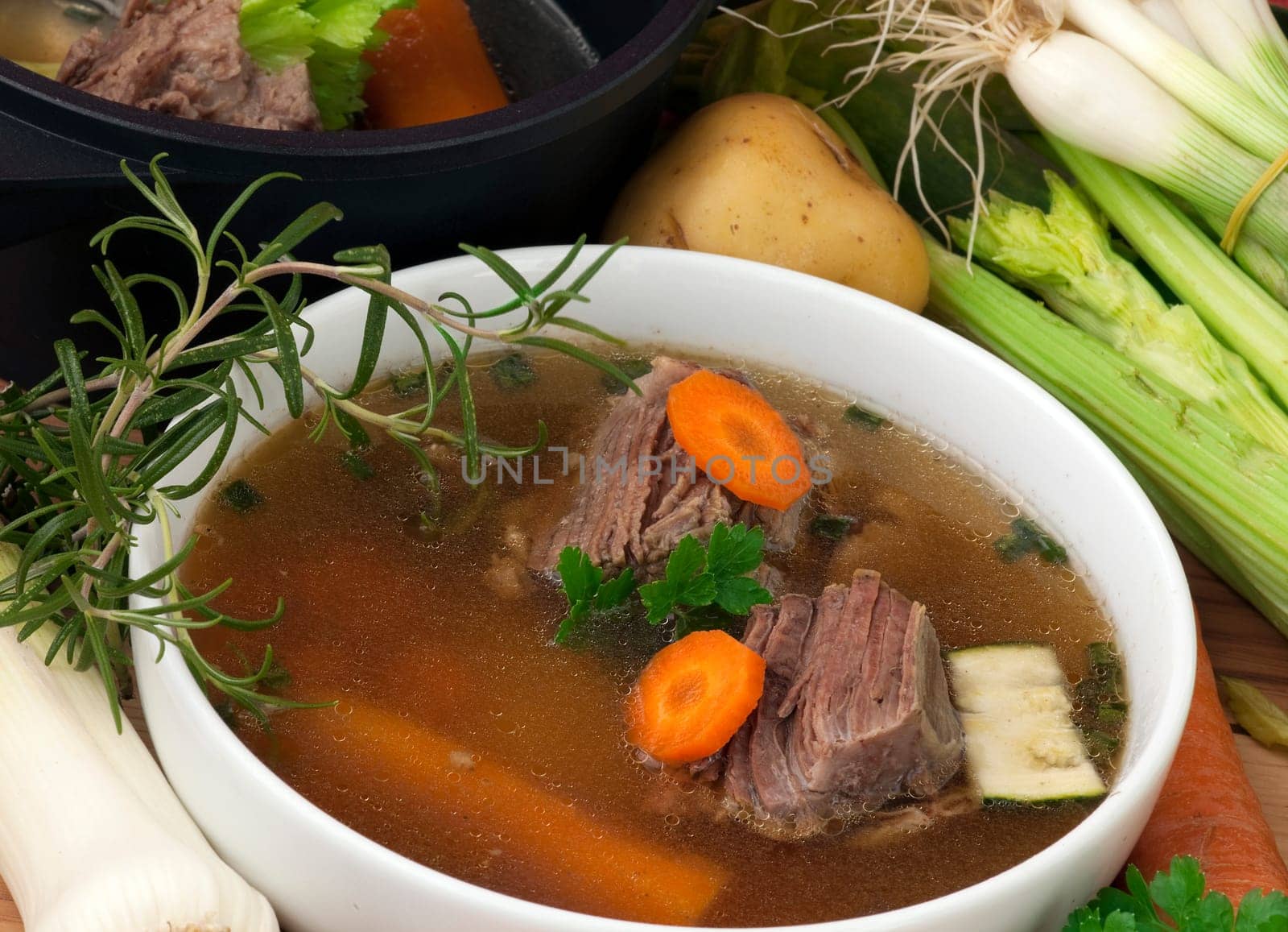 bowl of Beef Soupl with carrot, leeks, celery and spices, ready to serve.