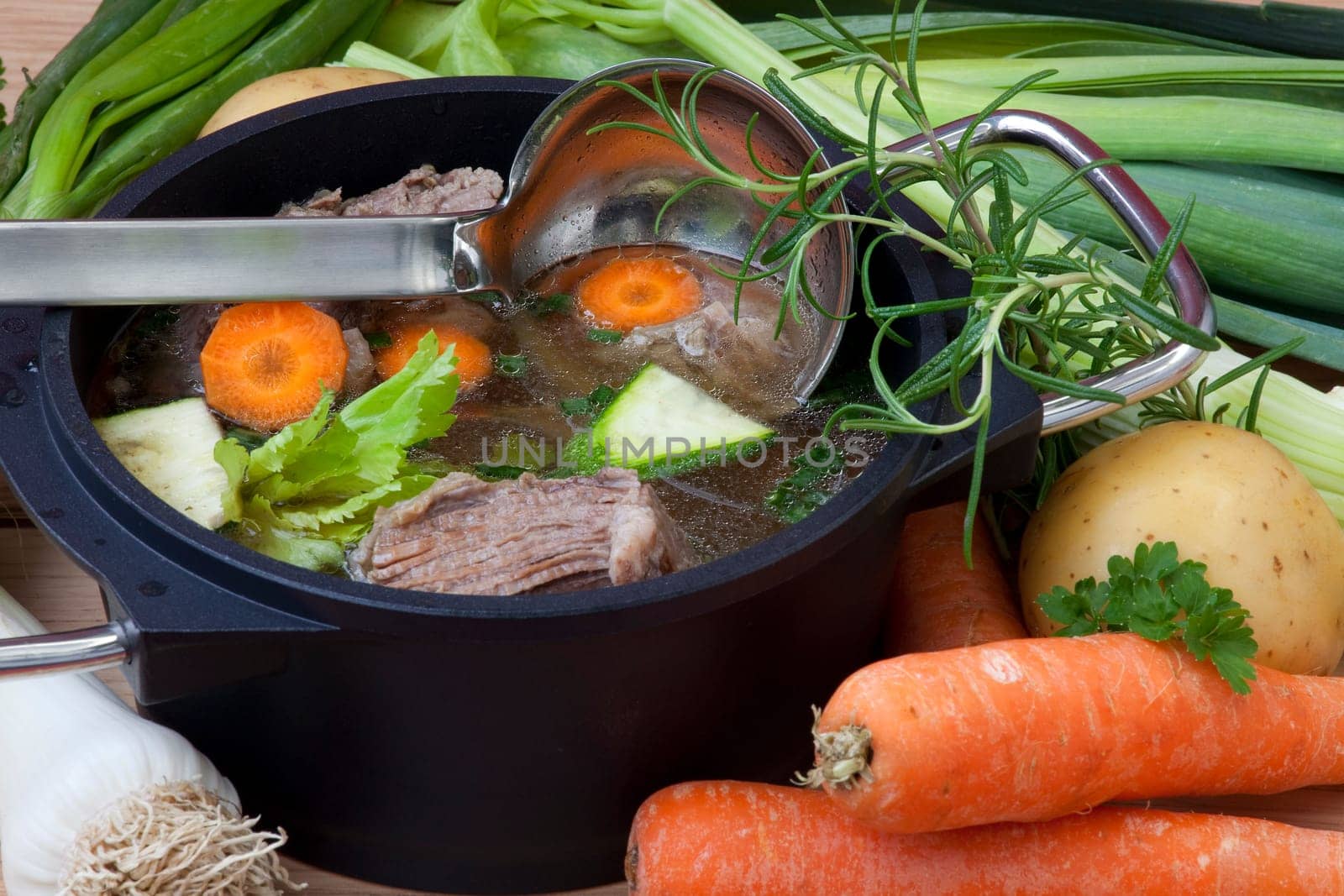 Beef boiled in pan with carrot, leeks, celery and spices for beef soup, ready to serve.