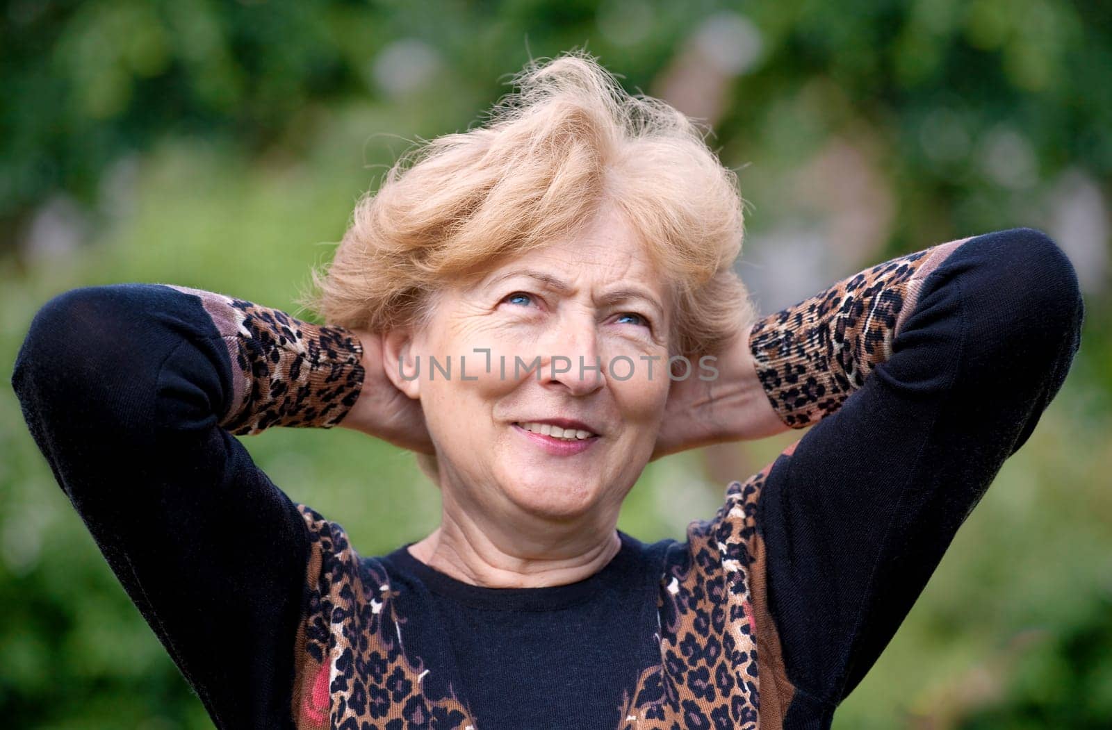 Youthful Senior Woman laughing... on a beautiful day.
