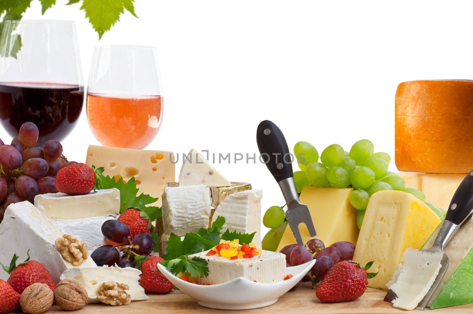 Glass of red wine and assorted cheeses with Fruit