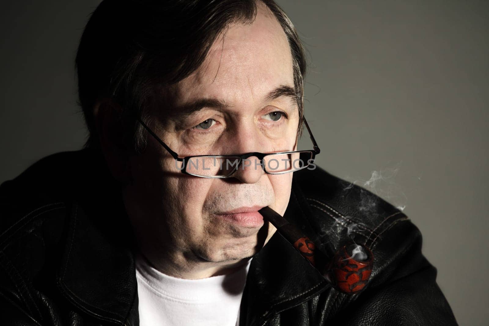 Senior man smoking a tobacco pipe