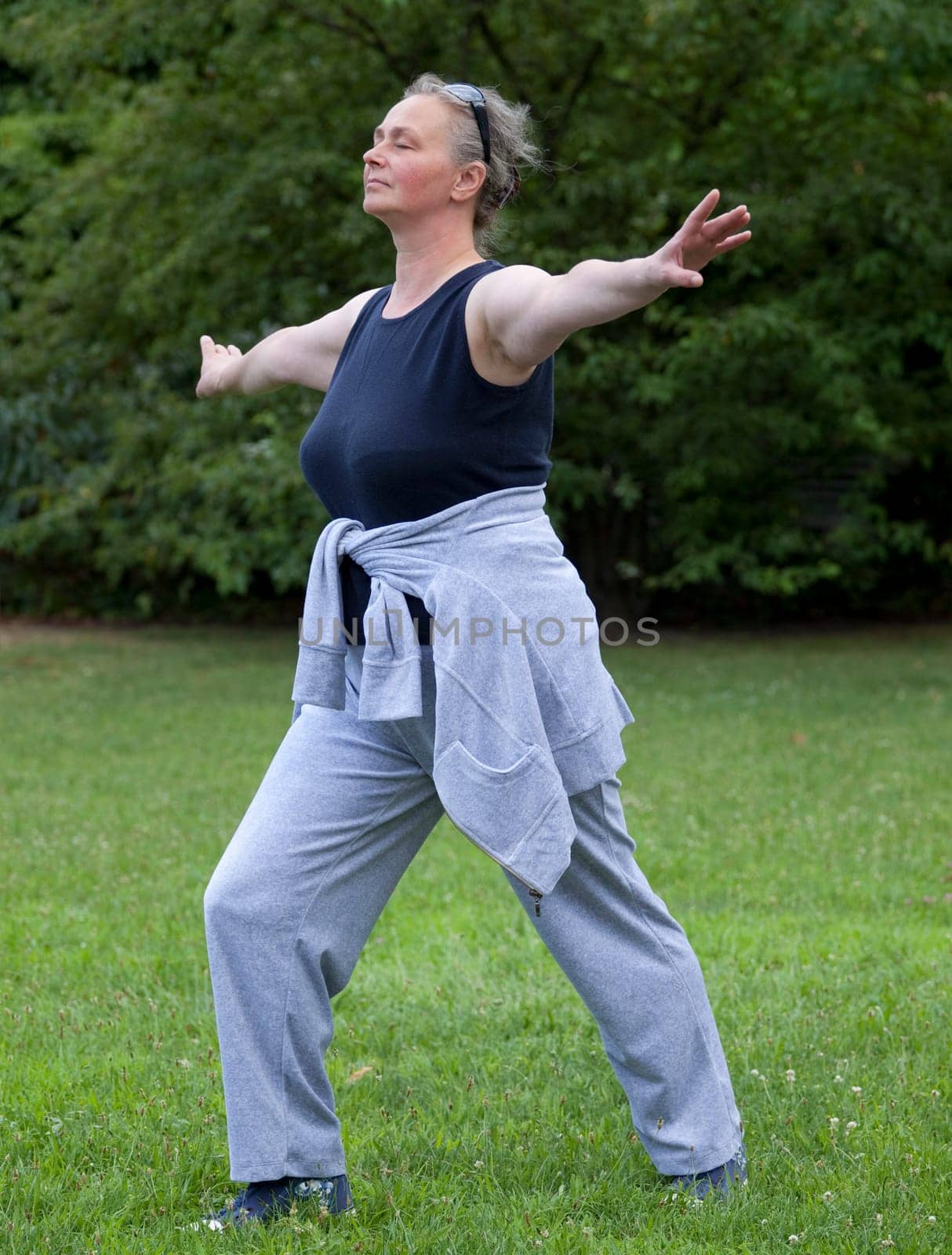 Senior woman doing Tai Chi against Outdoors