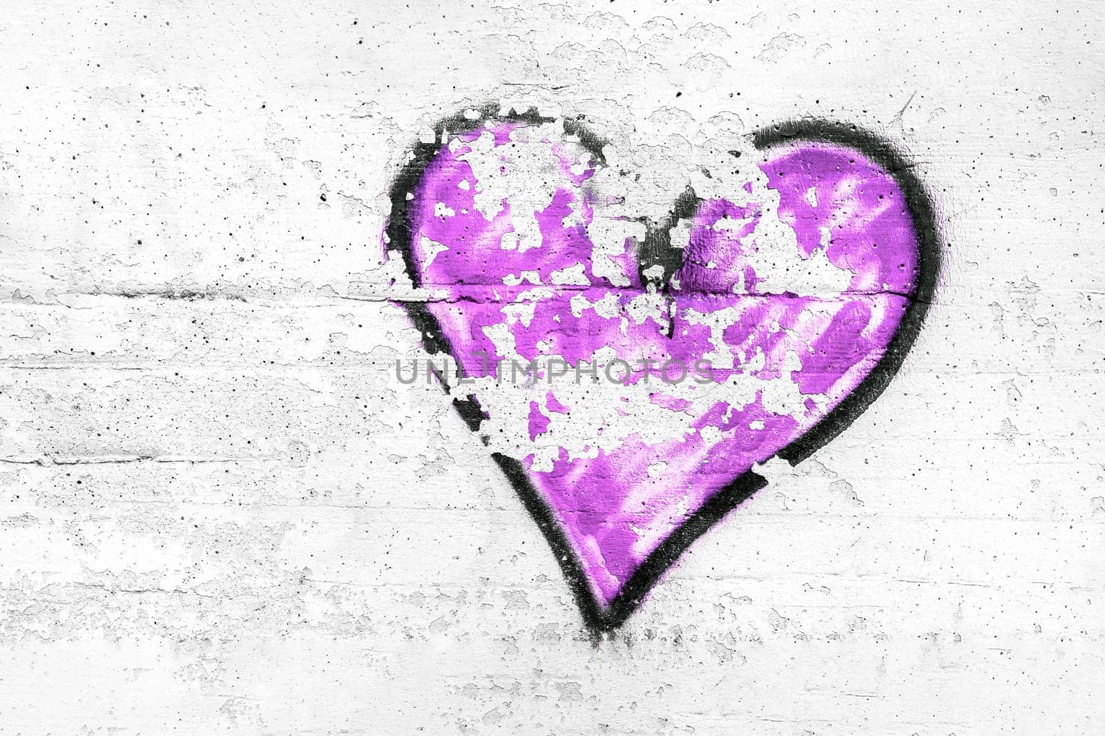 Painted violet abstract heart shape love symbol, dirty wall background, metaphor to urban and romantic valentine, grunge style.