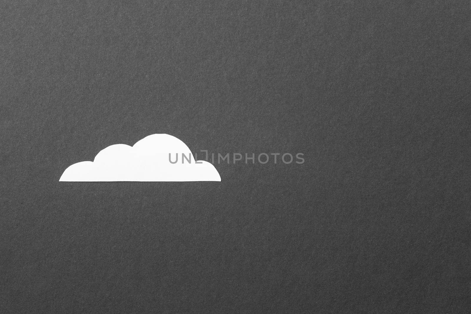 White cut out paper cloud on black background by Quils