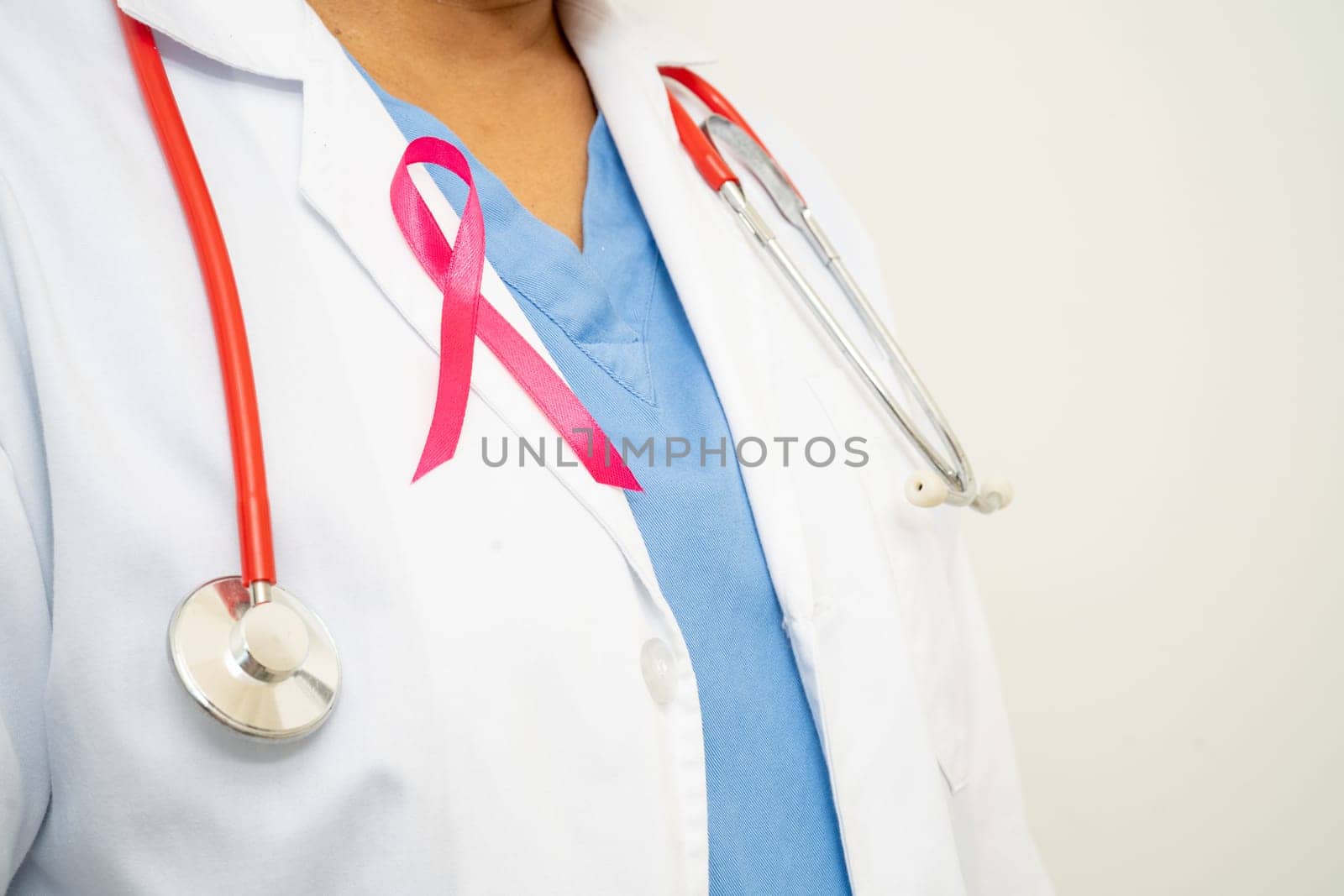 Breast cancer, Asian doctor woman with pink ribbon, symbol of World Breast Cancer Day.