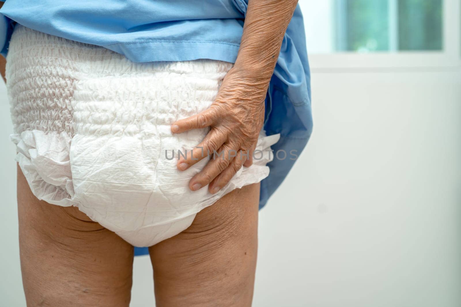 Asian senior woman patient wearing incontinence diaper in hospital, healthy strong medical concept.