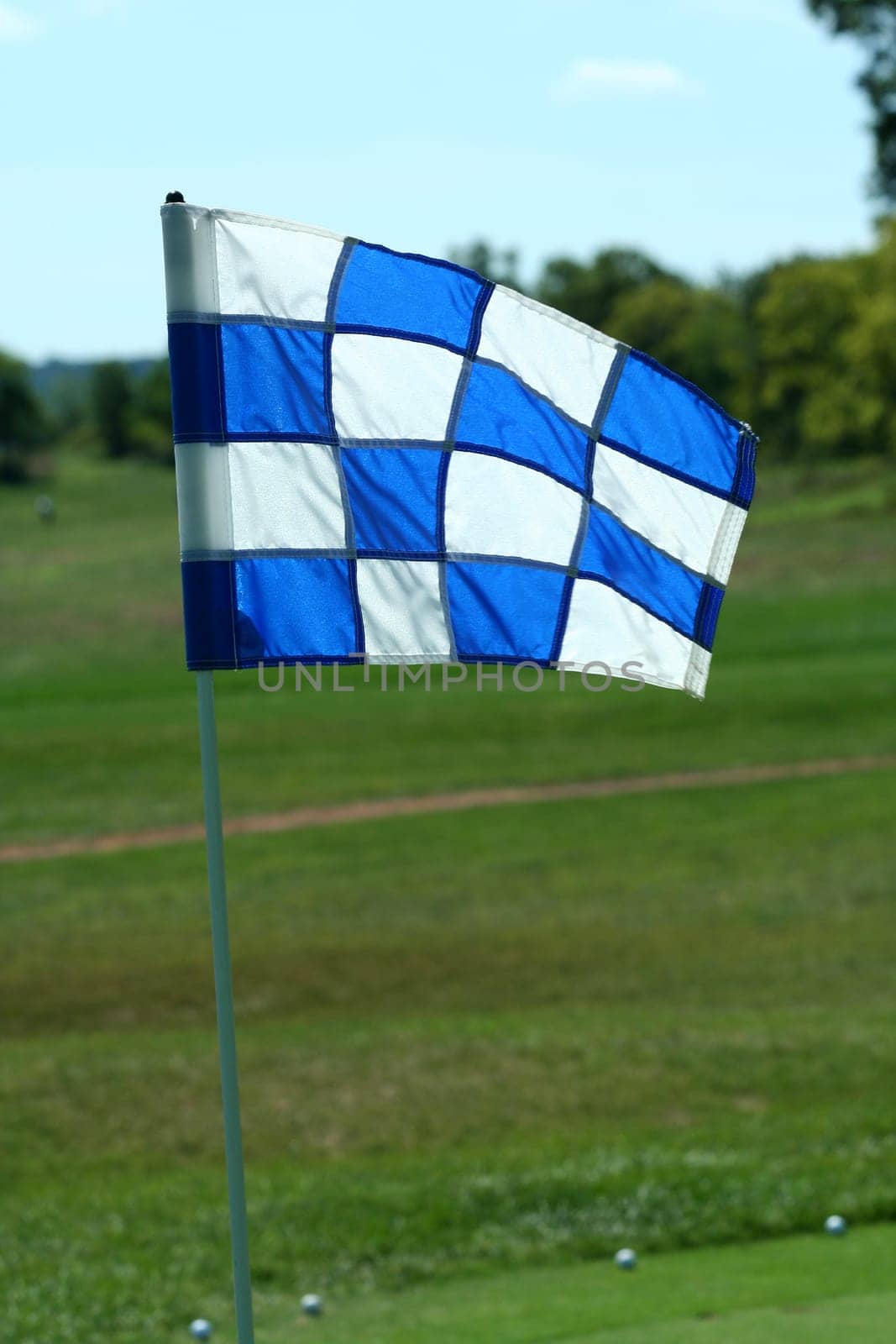 A Blue and white gofl green hole flag