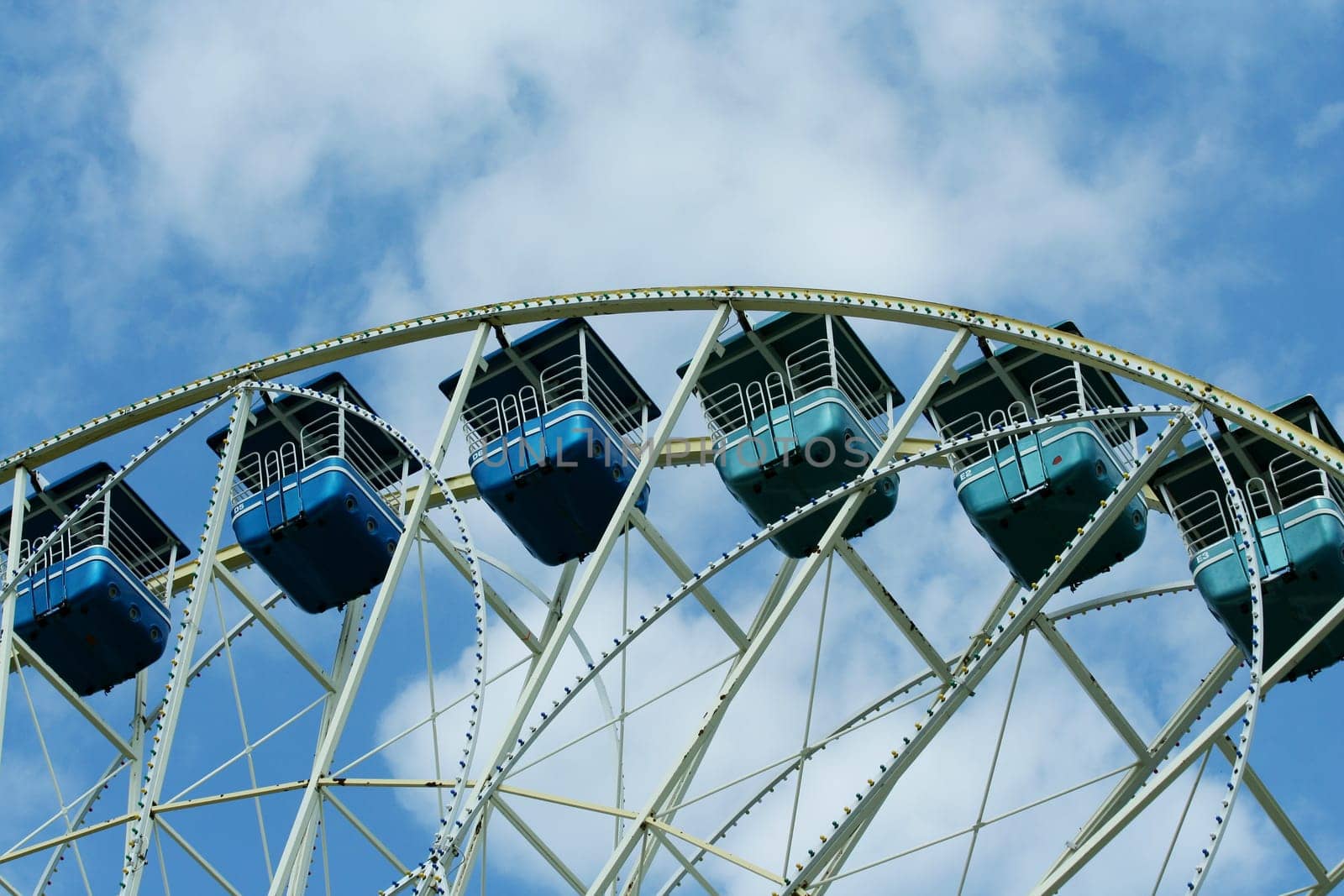 Ferris wheel against bule sky with clouds