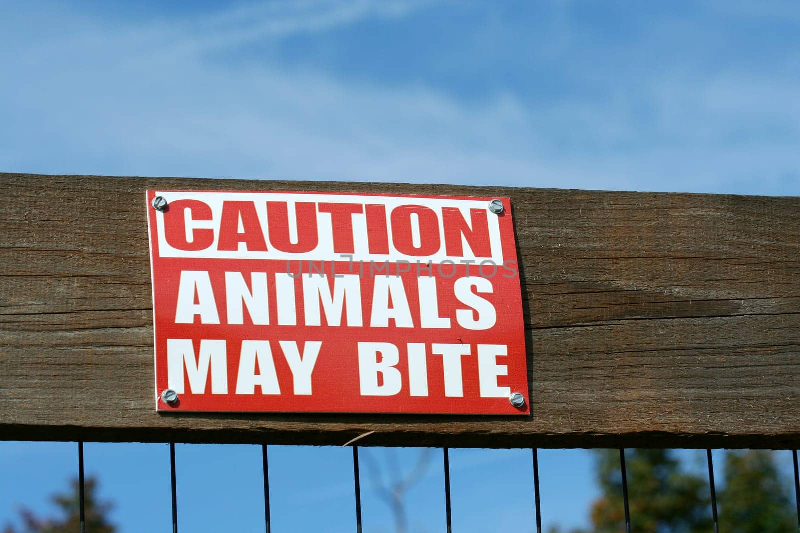 Caution animals may bite sign on a fence