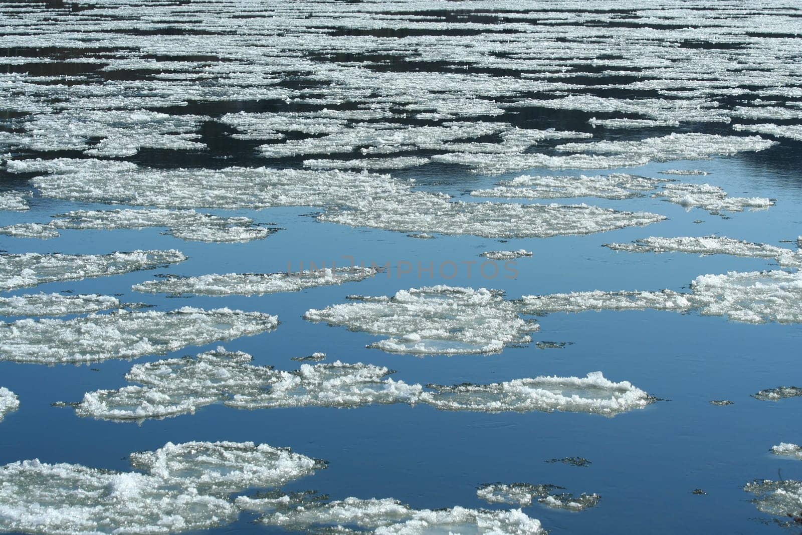 A Frozen river with icy patches