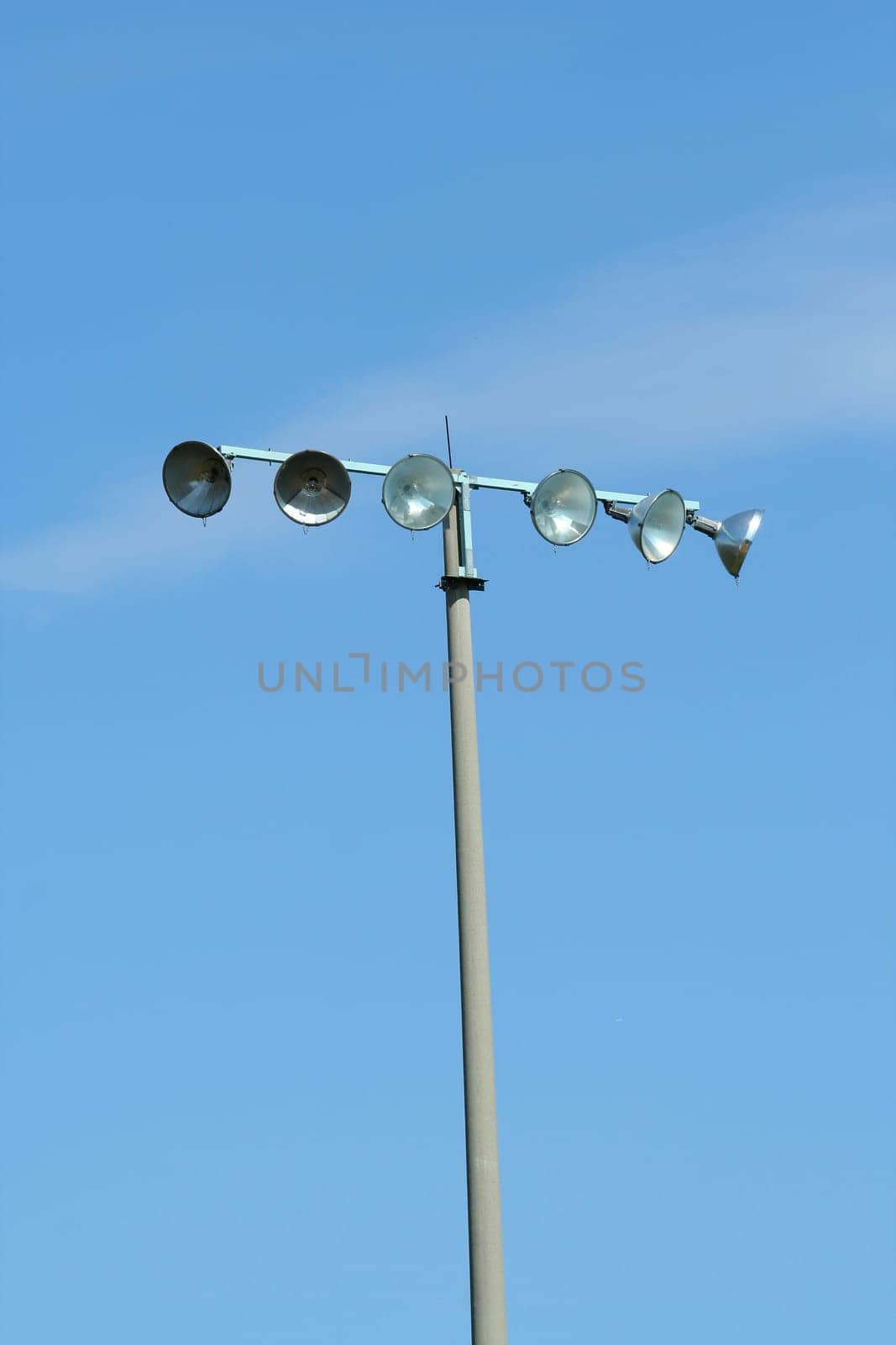Stadium lights agaist a blue sky