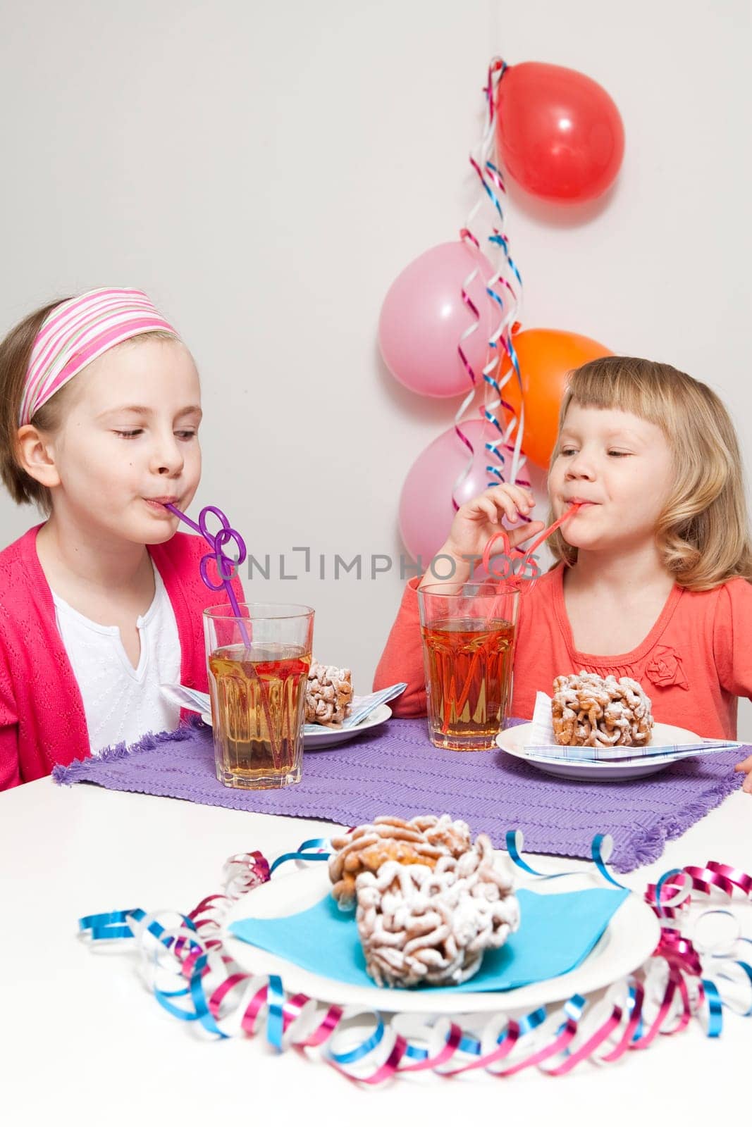 Girls having a traditional finnish May Day celebration, eating funnel cake, tippaleipa and drinking mead, sima