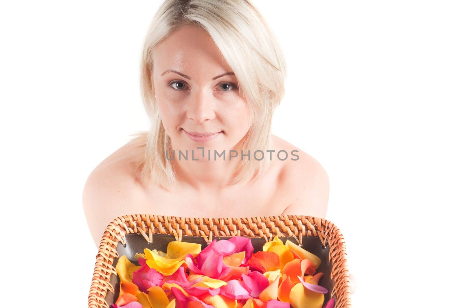 Shot of young sexy woman keeping plate with petals isolated on white