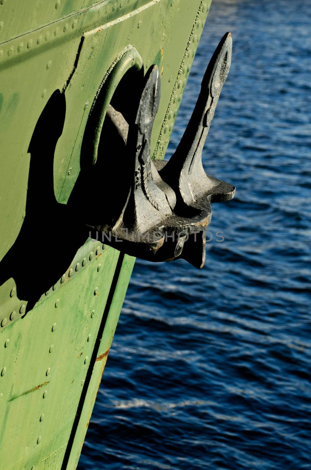a close up of an anchor on a green boat