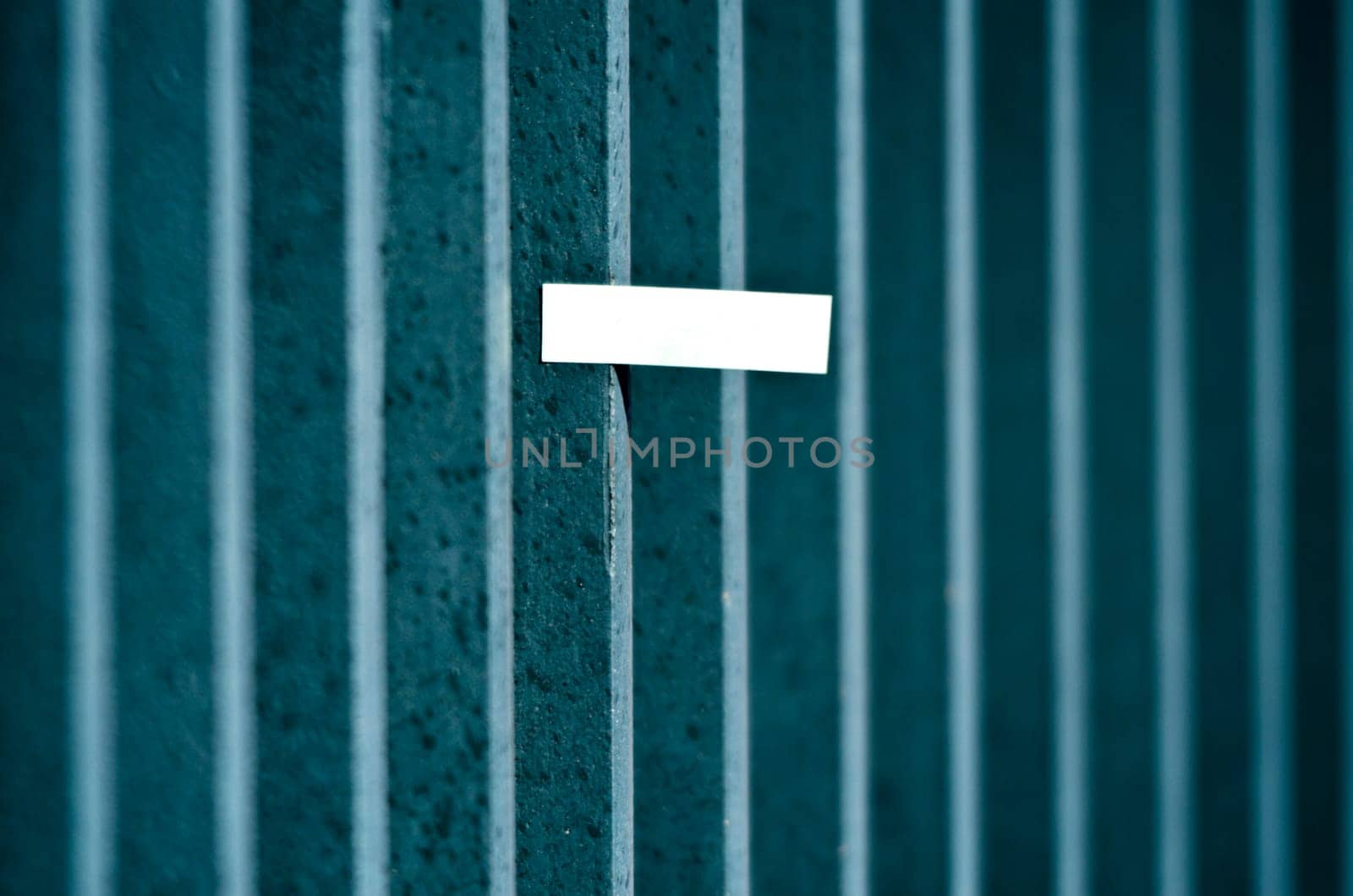 A single paper note on a steelbar fence