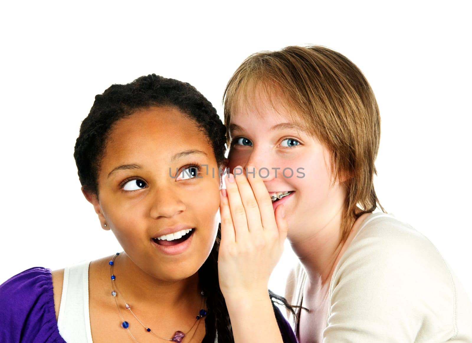 Isolated portrait of two diverse teenage girl friends whispering