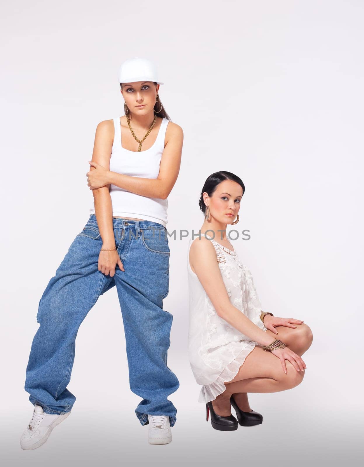 Two young woman posing and dance hip-hop style