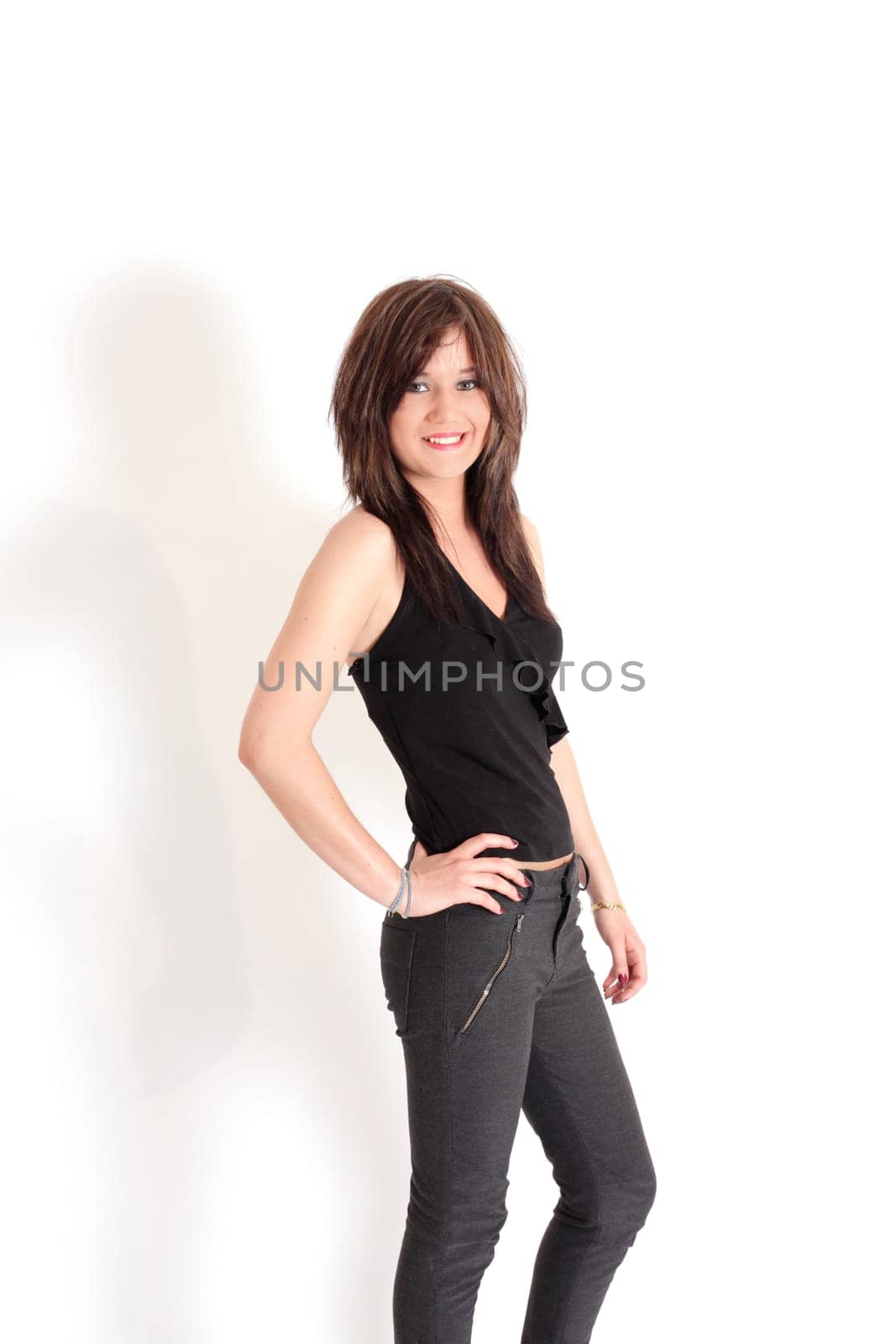 Young pretty teenage girl brunette in studio with long hair