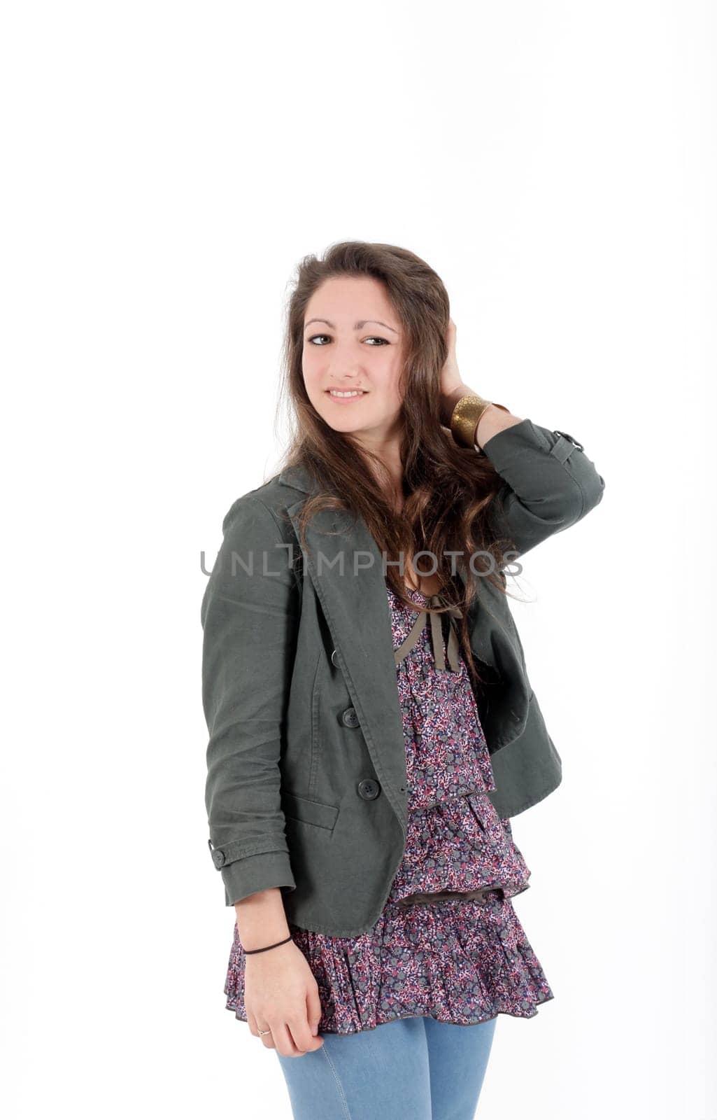 Young pretty teenage girl brunette in studio with long hair looking at the camera