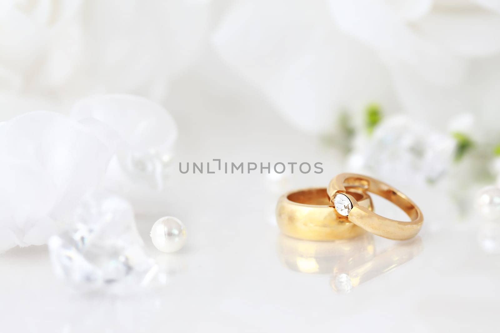 Wedding still life with beautiful golden rings and bouquet