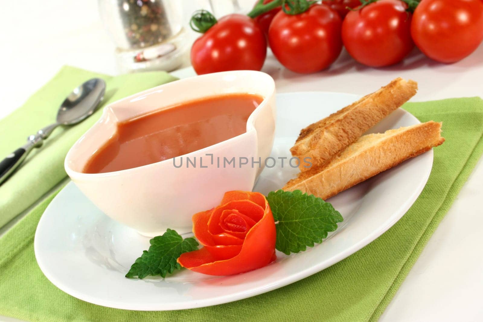 a bowl of tomato cream soup with toast