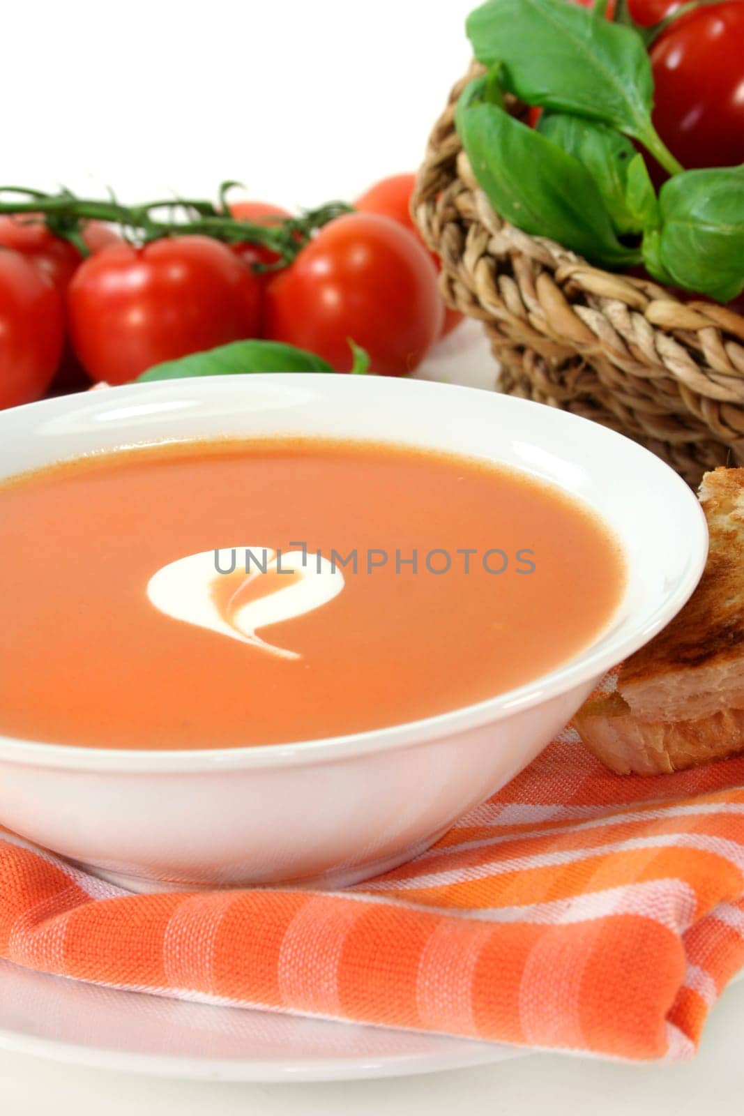 a bowl of tomato cream soup with toast