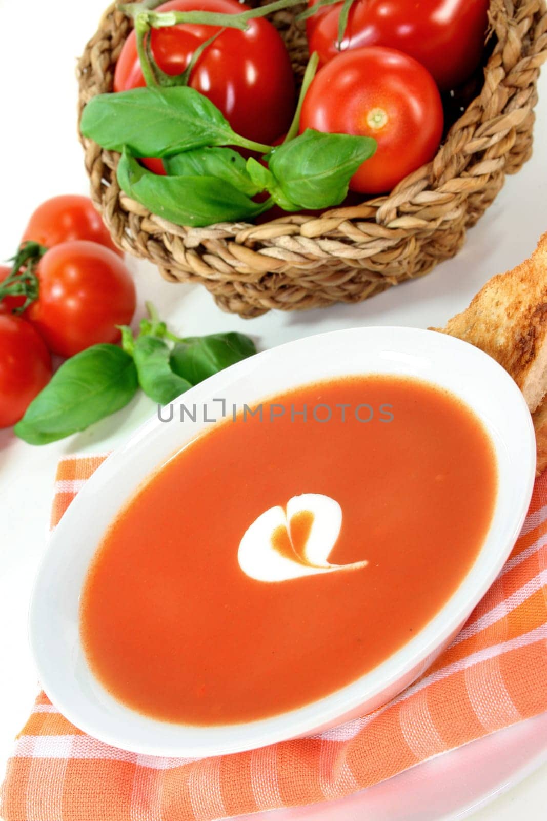 a bowl of tomato cream soup with toast