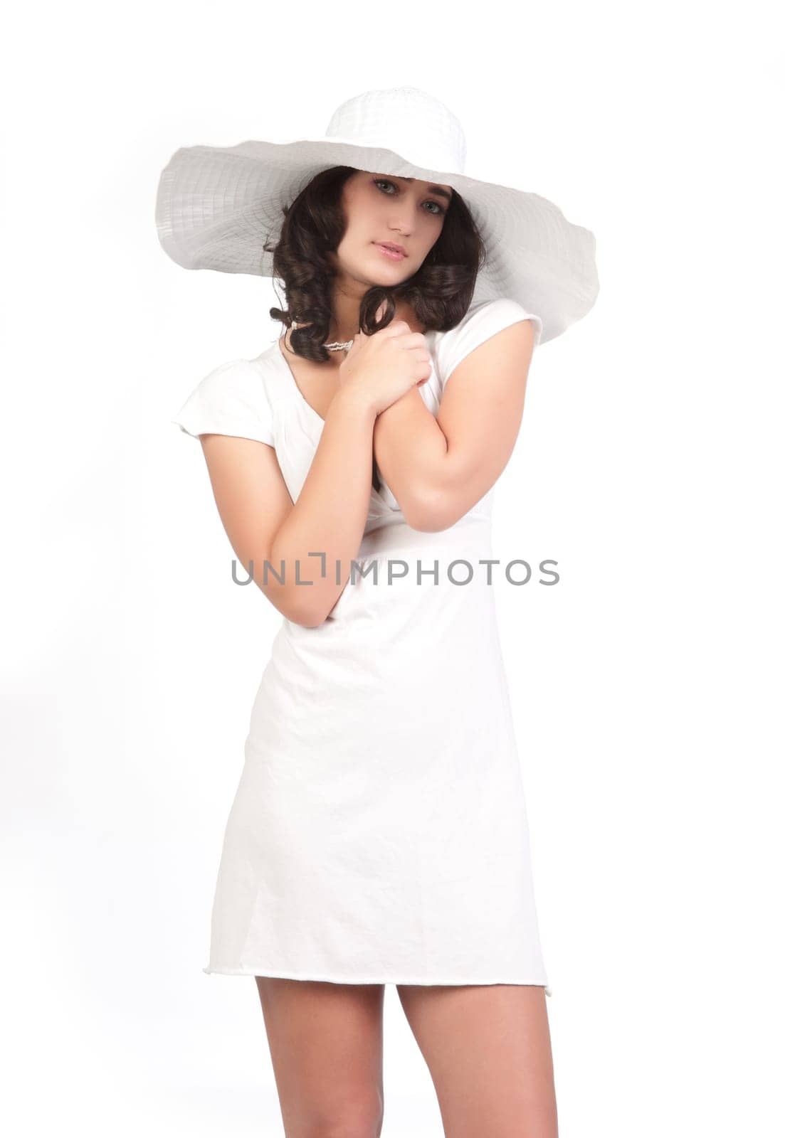 beautiful young fashion woman in white dress and hat