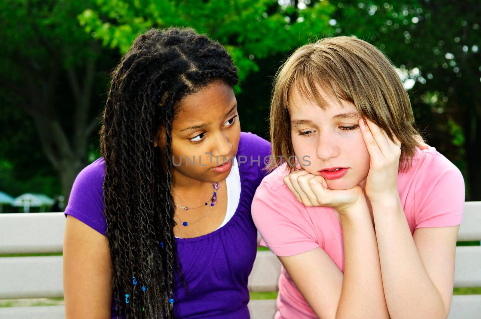 Teenage girl consoling her sad upset friend