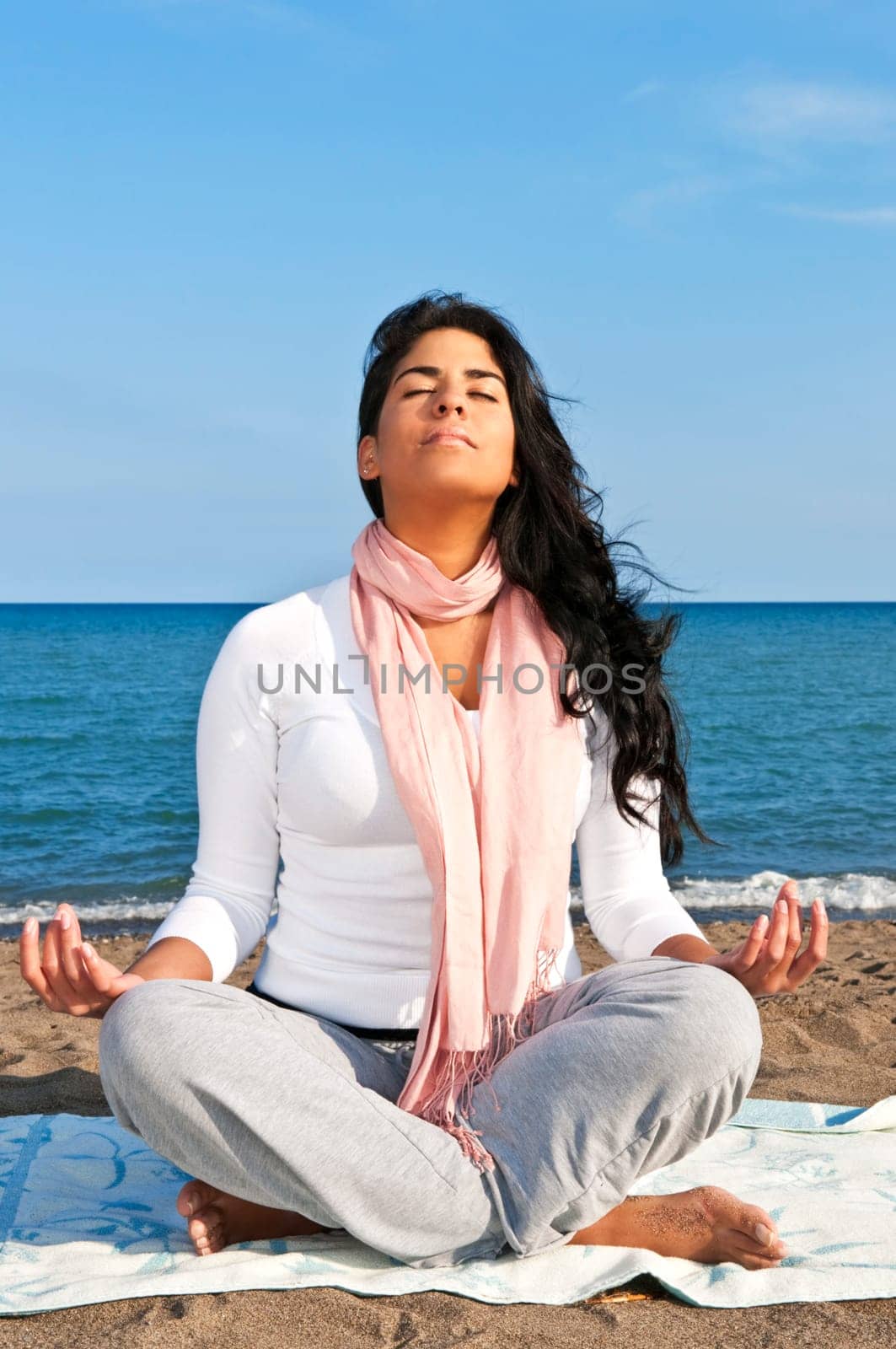 Portrait of beautiful native american girl doing yoga at beach