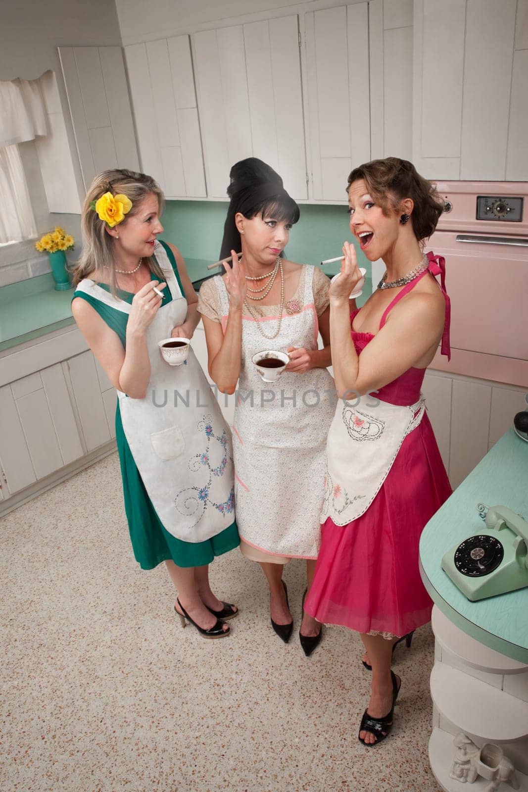 Three women gossiping in a kitchen while smoking cigarettes