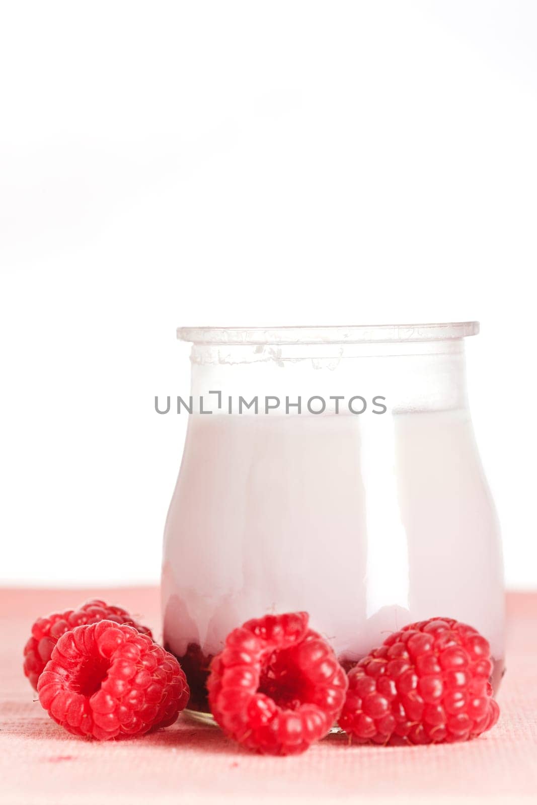 Delicious glass yogurt and fresh raspberries. Shallow depth of field