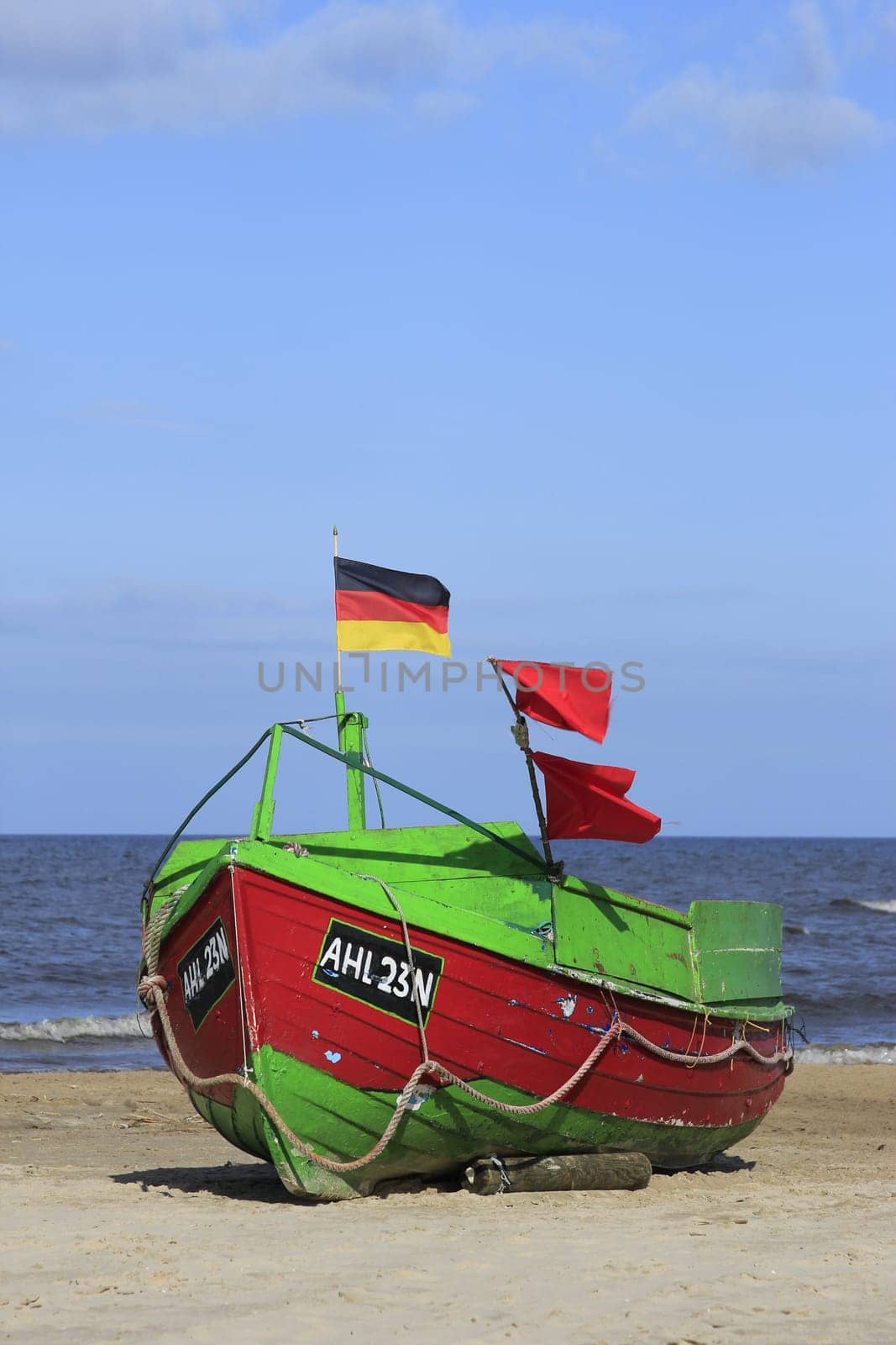 Fishing boat on the beach on the island of Usedom,Baltic Sea,Mecklenburg-Western Pomerania,in the background the pier of Ahlbeck