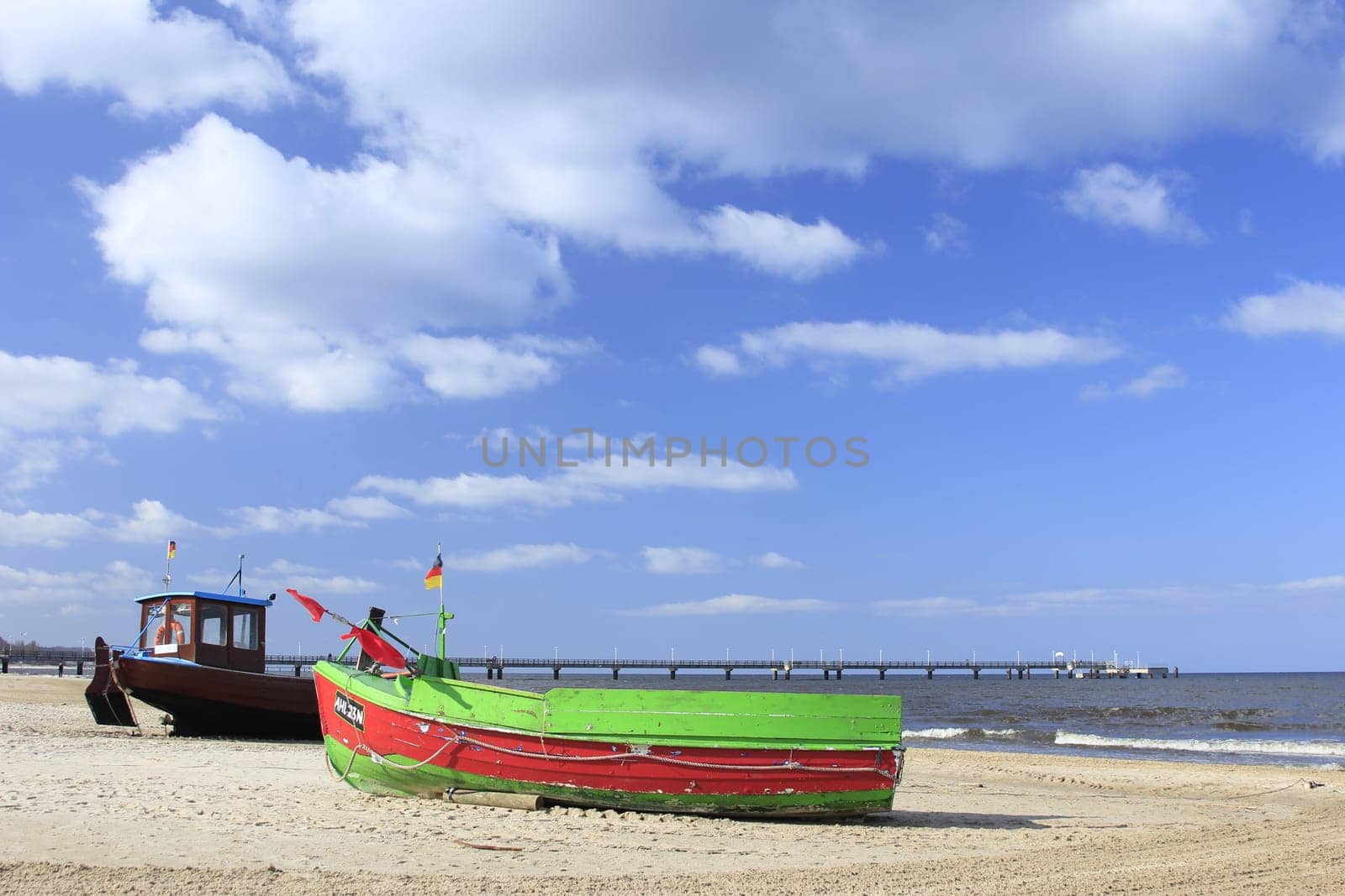 Fishing boat on the beach on the island of Usedom,Baltic Sea,Mecklenburg-Western Pomerania,in the background the pier of Ahlbeck